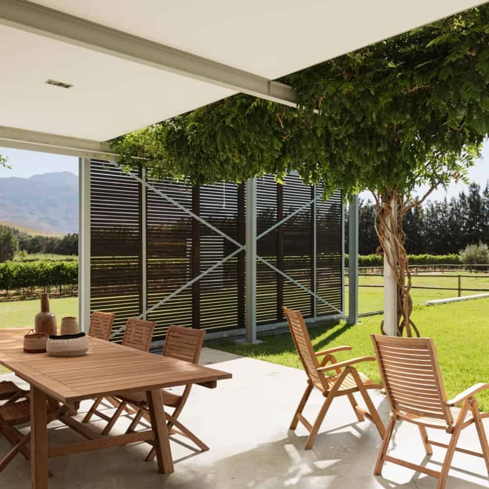 Spazio esterno con eleganti arredi in legno e viste sulla natura.