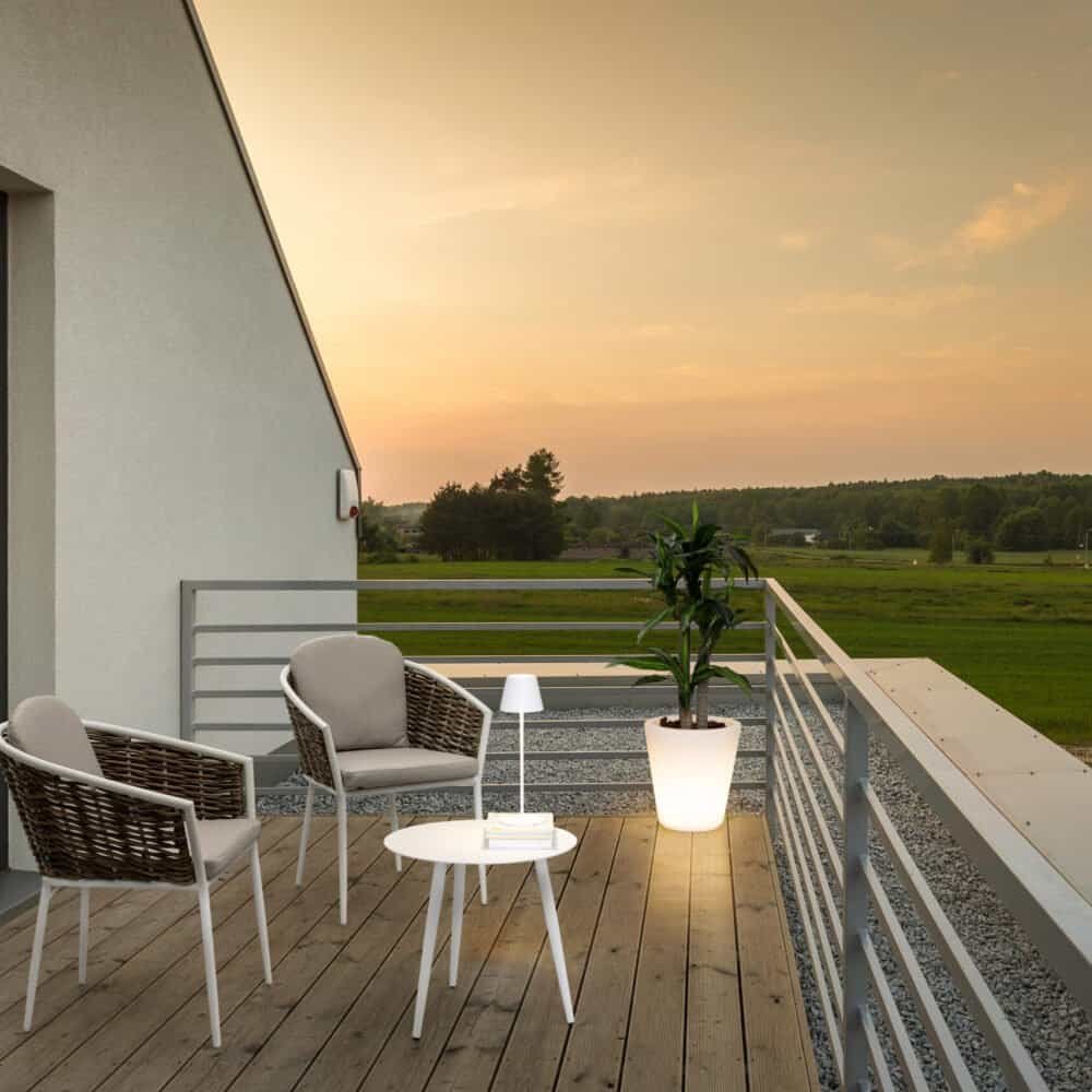 Situato su un edificio moderno, questo balcone offre una vista panoramica sulla campagna e un'atmosfera accogliente.