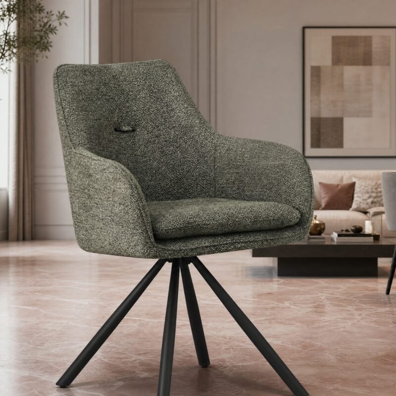 Green patterned armchair as the focal point in a modern living room with plants, a sofa, and framed art in the background.