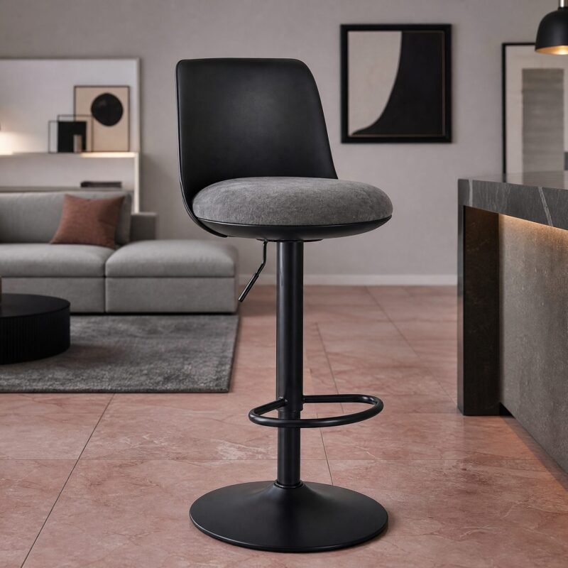 Black bar stool with gray cushion at a marble kitchen island in a modern living room setup.