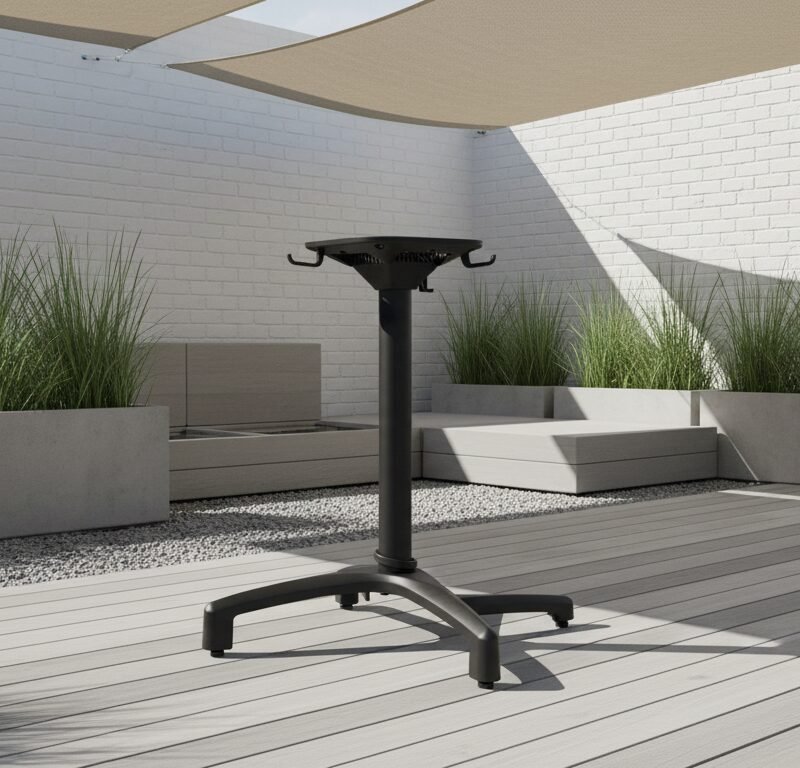 Black adjustable-height pedestal standing on a four-leg base in a modern outdoor patio with planters and seating.
