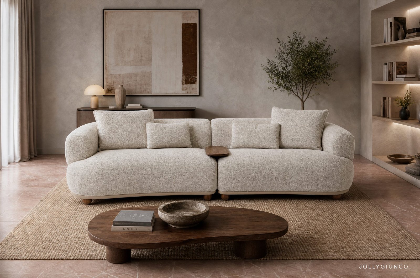 DIVANO 4P C-C CHEOPE10 - JOLLYGIUNCO Neutral living room with a large beige sectional sofa, round wooden coffee table, and abstract wall art. A tall plant and built-in shelves sit to the right.