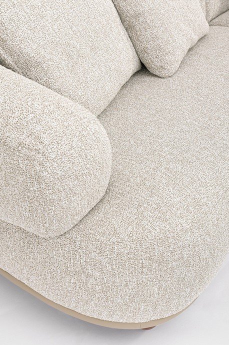 DIVANO 4P C-C CHEOPE4 - JOLLYGIUNCO Close-up of cream-colored, textured fabric upholstery on a rounded sofa arm and cushion edge.