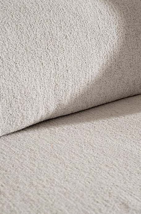 DIVANO C-C AFRODITE8 - JOLLYGIUNCO Close-up of beige textured fabric on a sofa cushion piece in a living room setting.