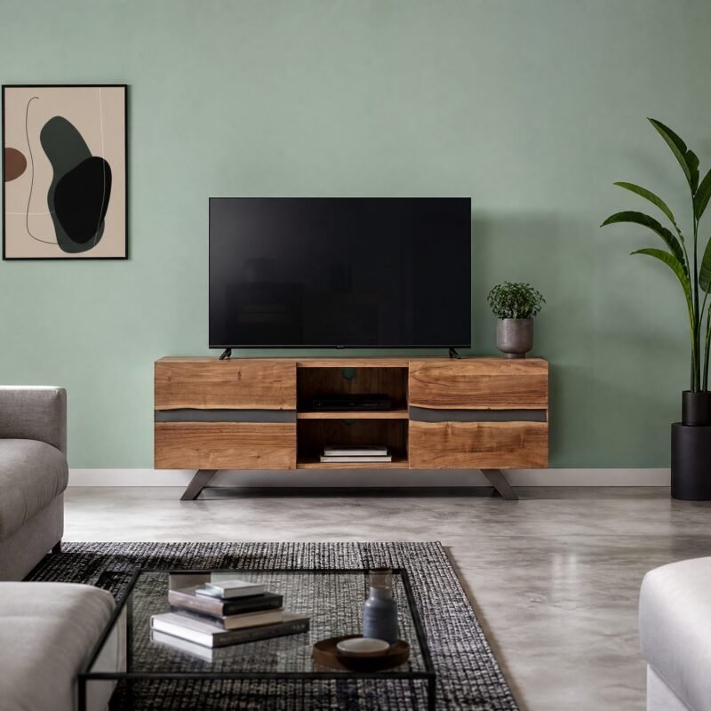 Living room with a flat-screen TV on a wooden cabinet against a sage-green wall, flank by a tall plant and abstract art poster to the left.
