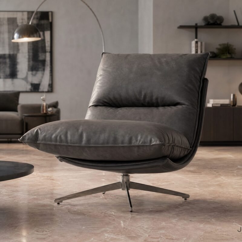 Modern living room with a large gray leather lounge chair, black coffee table, and plants in a neutral-toned space.
