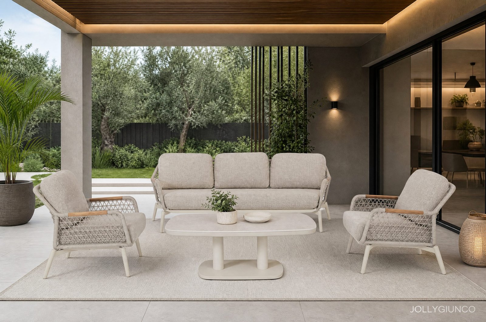 POLTRONA C-C EULERO PELICAN10 - JOLLYGIUNCO Modern outdoor patio with beige wicker seating on a light rug, glass doors to an indoor space, and greenery beyond.